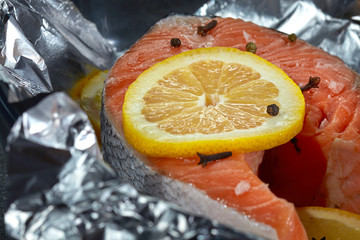 Salmon steak with lemon, fish fillet, cooked for baking in foil.
