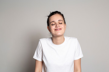 Lovely woman smiling from happiness and pleasure. Isolated on white background.