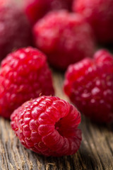 Fresh raspberries on wooden table close-up