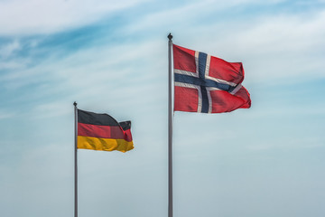 Flags of EU, Germany, Norway, Sweden on blue sky. Concepts of politics, tourism, economy, cooperation, eurozone and other.