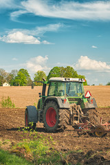 Tractor working on the farm, a modern agricultural transport, a farmer working in the field, fertile land, tractor on a sunset background, cultivation of land, agricultural machine