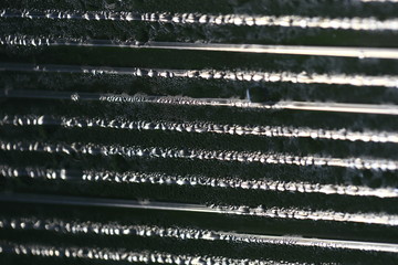 Water droplets on cellular polycarbonate, pattern and structure with variable scale and direction.