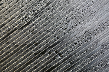 Water droplets on cellular polycarbonate, pattern and structure with variable scale and direction.