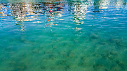 Turquoise sea surface background with reflections in the water