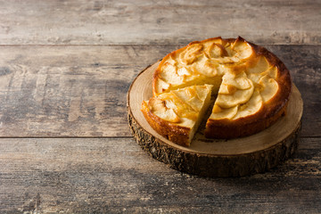 Homemade apple pie on wooden table. Copyspace