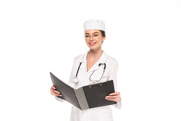 young smiling doctor in white coat with stethoscope and folder isolated on white