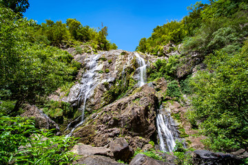 Fototapeta na wymiar Waterfall in tropical forest at Khlong Lan National park, Kamphaeng Phet, Thailand.