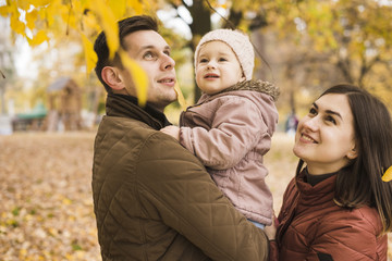Family in park admiring of autumn nature