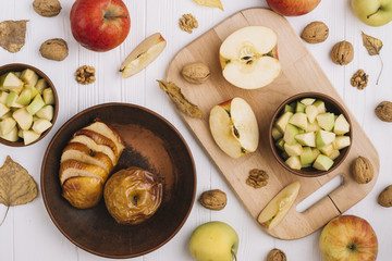 Assorted apples near walnuts and leaves