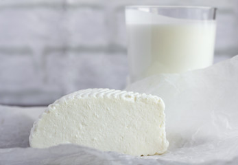 fresh soft Adyghe cheese and kefir on the table, useful dairy products for healthy eating
