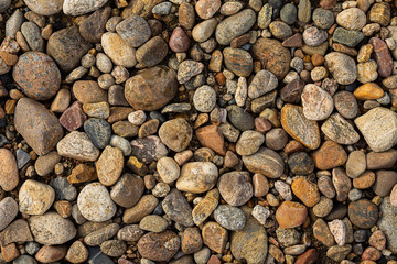 Texture of coastal pebbles on the seashore. Desktop Wallpaper.