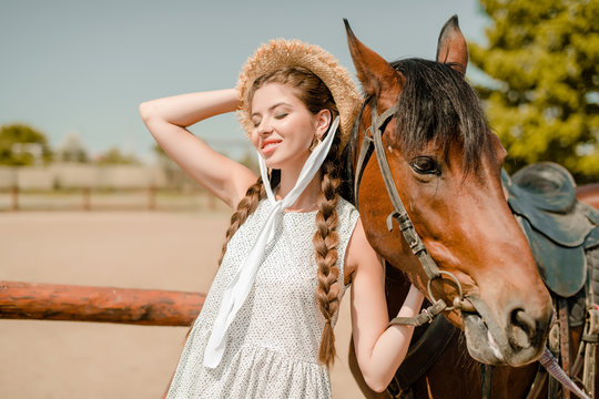 countryside cowgirl with a horse on a farm