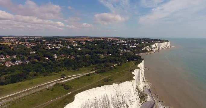 Aerial view of picturesque walking coastal path over white cliffs of Dover, southeast Kent, England, on a sunny summer day .
