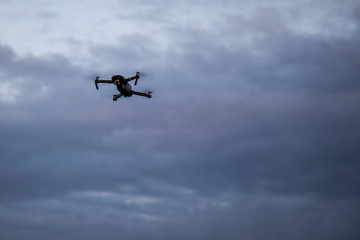 Drone in the sky. Unmanned aerial vehicle flying in the air
