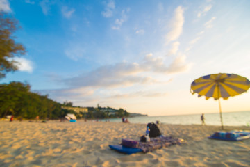 Blurred group of people enjoying sunset on sea beach