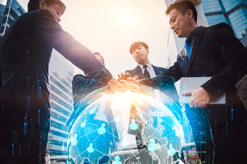 Close up of businessmen shaking hands. Global network and a world map in the foreground. block chain concept.