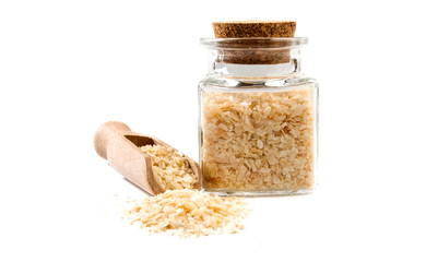 dried onion in wooden scoop and jar on isolated on white background. front view. spices and food ingredients.