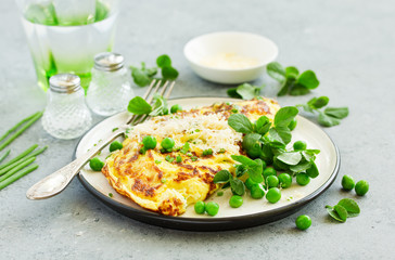 Breakfast. Frittata Italian omelet with green peas and salad.