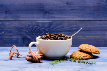 Cup full coffee brown roasted bean blue wooden background. Caffeine concept. Cafe drinks menu. Arabica robusta coffee variety. Beverage for inspiration and energy charge. Fresh roasted coffee beans