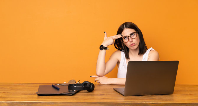 Business woman in a office with problems making suicide gesture