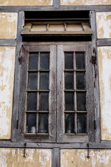 Fototapeta na wymiar Window with the wooden carved architrave