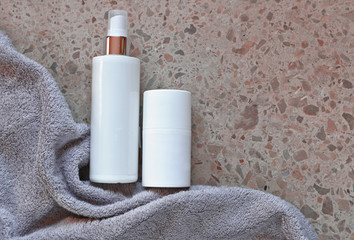bottle with creme with towel in bathroom  
