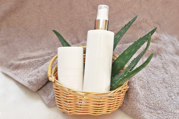 Aloe vera leaves with cosmetic bottles 