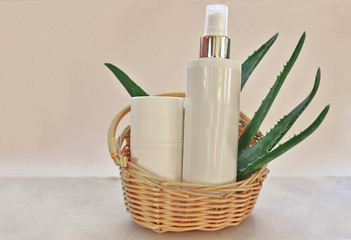 Aloe vera leaves with cosmetic bottles 