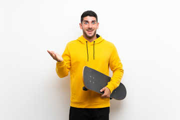 Handsome young skater man over isolated white wall with shocked facial expression