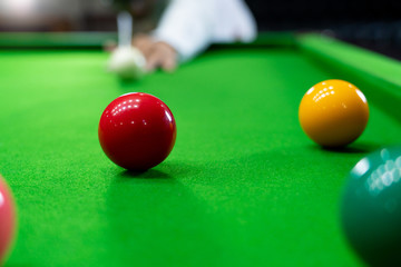 Game snooker billiards or opening frame player ready for the ball shot, athlete man kick cue on the green table in bar.