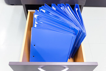 blue file folder documents In a file cabinet retention of contracts.