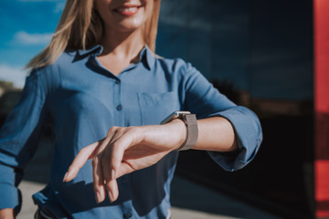 Cropped photo of adult woman waiting for meeting and checking time