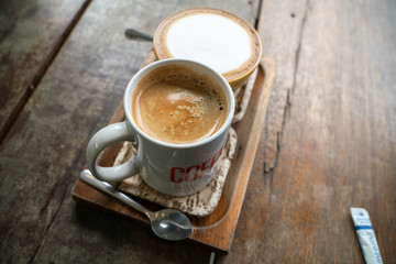 Hot latte coffee and espresso coffee in cup on wood table