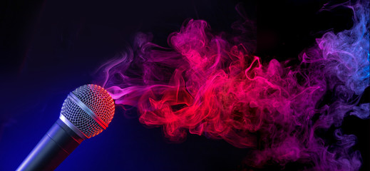 microphone in a purple-bluish smoke on black background - Powered by Adobe