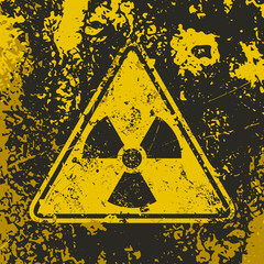 Fototapeta premium Grunge poster Radioactive. Vector illustration of triangle sign Ionizing radiation on grunge dirty yellow background. It can be used as a poster, t-shirts and other design projects.