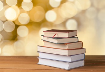 Old stacked books on wooden background