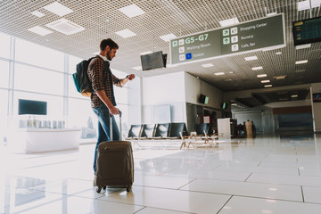 Young man is waiting for flight indoors