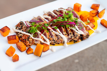 Ahi Tuna with butternut squash cubes topped with microgreens