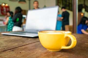 Cup of hot latte art coffee on wood table