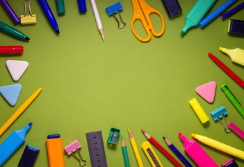 School office supplies on a desk with copy space. Back to school concept. School supplies on green background. Back 2 school concept