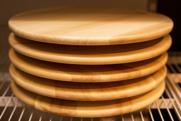 Modern wooden pizza boards on the shelf. Front view.