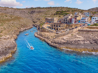 Fototapeta premium Blue Grotto in Malta. Pleasure boat with tourists runs. Aerial top view