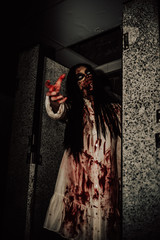 Portrait of asian woman make up ghost face with blood,Horror scene,Scary background,Halloween...