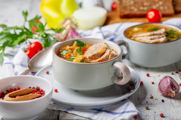 Soup with fresh cabbage and meat in ceramic bowl.