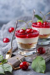 Light cheesecake with cherry jelly in a glass.