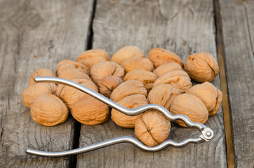 Delicious walnuts on wood table with nutcracker