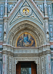 Italian Renaissance. Architectural details of awesome marble facade with sculptures, painting, decorations. Duomo Florence Cathedral is the third largest church in the world. Italy, Florence