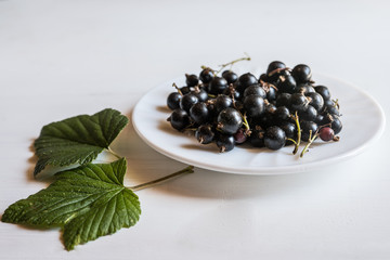 close up of a bowl with fresh organic ripe juicy black cherries 
