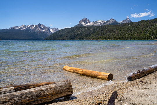 Summer view at Redfish Lake, located outside Stanley Idaho in the Sawtooth National Forest wilderness. Logs in foreground