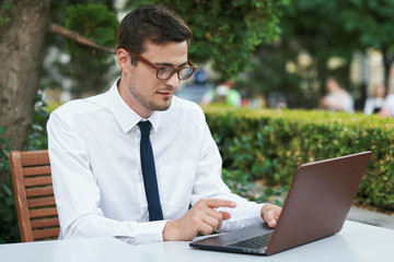 businessman working on his laptop in the park